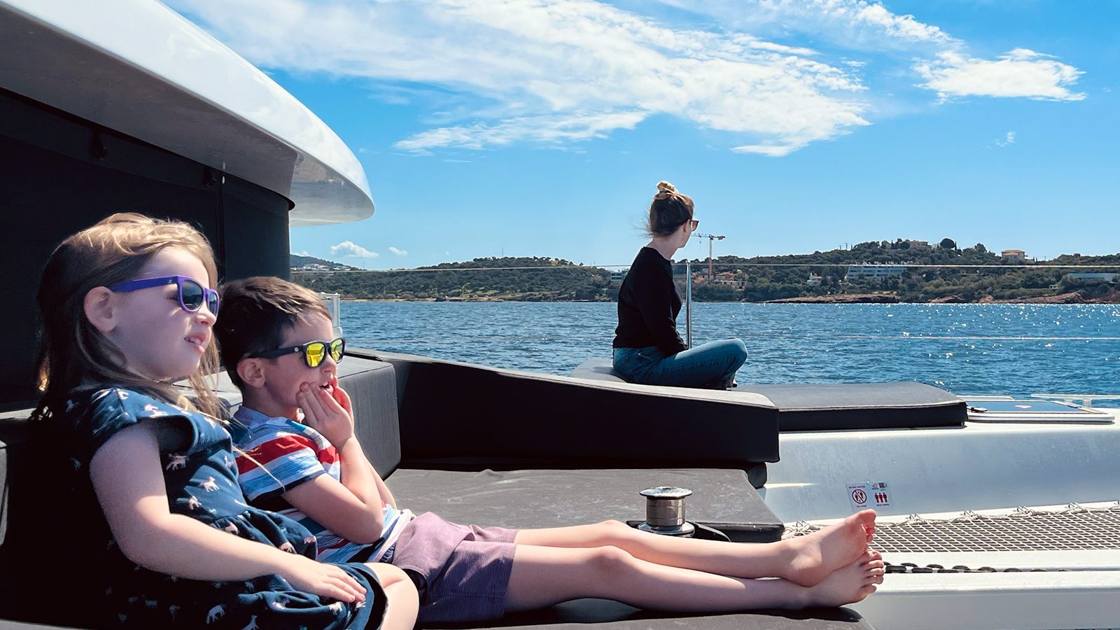 Calvin and Millie lounging on the catamaran with Carol in the background
