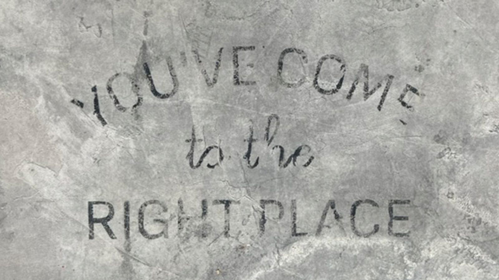 Words painted on the ground outside a Naxos restaurant reading You've Come to the Right Place