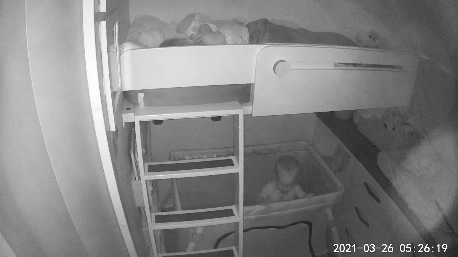 Night vision camera view of the kids' room inside Colletta, showing baby Millie awake in her crib at 5:26am