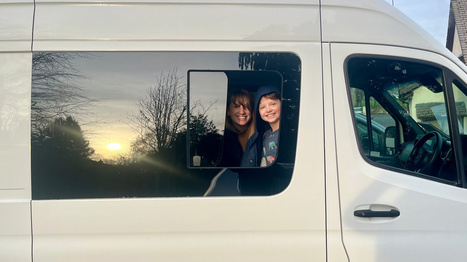Carol and Calvin peeking through the Sprinter's newly installed side window